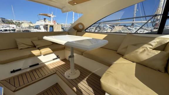 The dining area on motor yacht Breathe features comfortable seating and an elegant table.