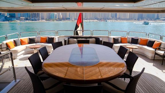 Make your Dubai yacht rental unforgettable in the stylish open dining area of the Code 8 yacht.