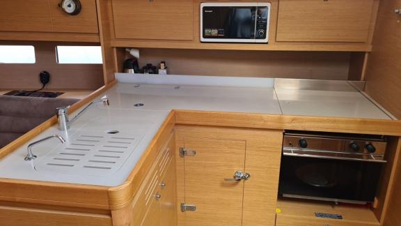 The kitchen of sailing yacht Desiree II is equipped with modern appliances and features a stylish design.