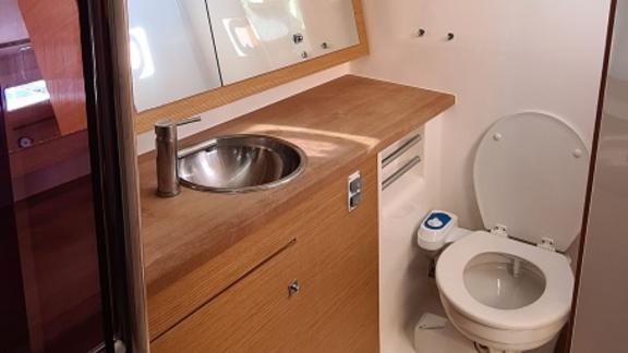 The bathroom of sailing yacht Desiree II features a modern design with wood accents.