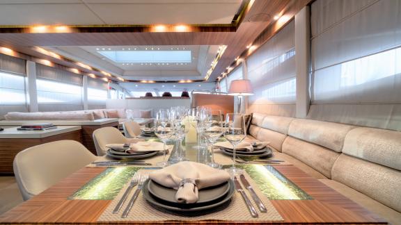 Enjoy a luxurious dinner in the stylish dining room of the motor yacht O'Pati.