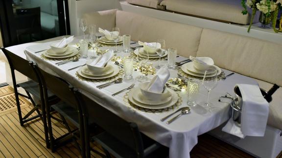 Beautifully set dining table with dishes, glasses, and decorations on Lagoon 620 Adriatic Lion