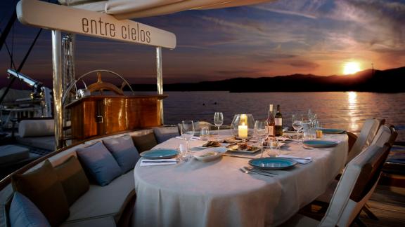 Set table on the gulet Entre Cielos, ready for a sunset dinner with breathtaking views.