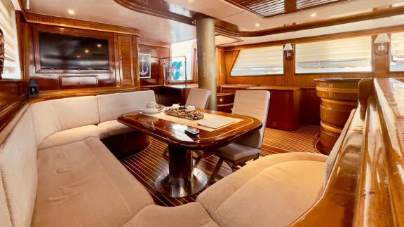 Elegant interior of the Gulet Diva Deniz, with upholstered furniture, wooden fittings and large windows.