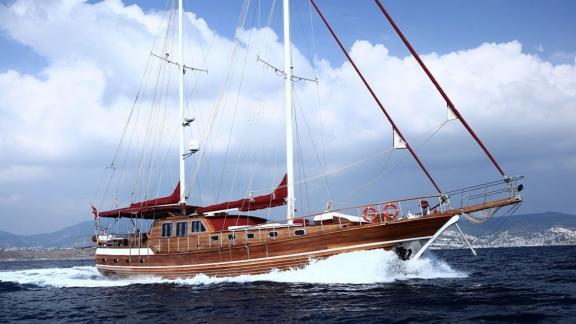 Traditional wooden Gulet Doris sailing off Bodrum coast, perfect for luxury yacht excursions.