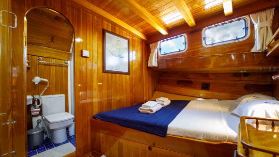 Relax in the cozy cabin of Gulet Ya Selam with a private bathroom and wood paneling.