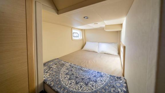 Cozy cabin of motor yacht Moonlight with a comfortable bed and spacious ambiance.