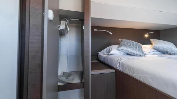 The bedroom on the Bali 5.4 catamaran in Italy features a practical wardrobe and offers luxurious sleeping comfort.