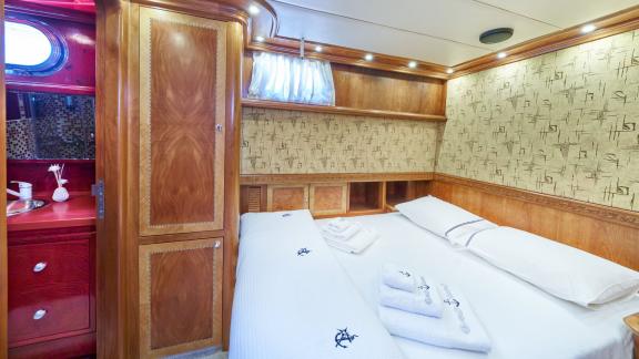 A guest cabin on board the Gulet Lotus with a comfortable double bed