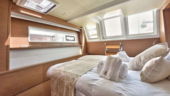 Sunlit cabin with double bed and large windows on Lagoon 450F Adriatic Tiger