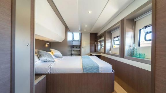 The bright and spacious bedroom on the Bali 5.4 catamaran in Italy offers luxurious comfort and modern amenities.