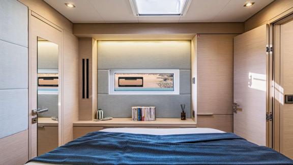 The elegant bedroom of catamaran Happy with window and modern design provides a comfortable environment.