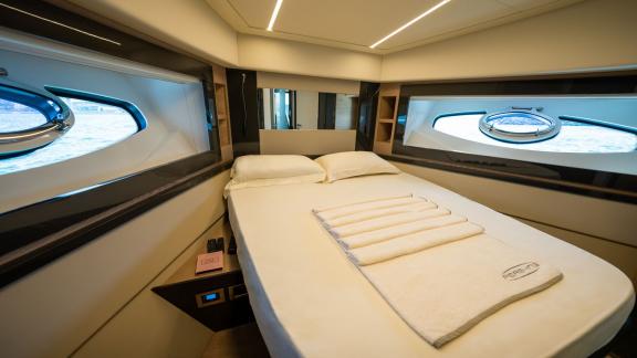 Experience comfort in the modern double guest cabin of Pershing 70 with your Dubai luxury yacht rental.