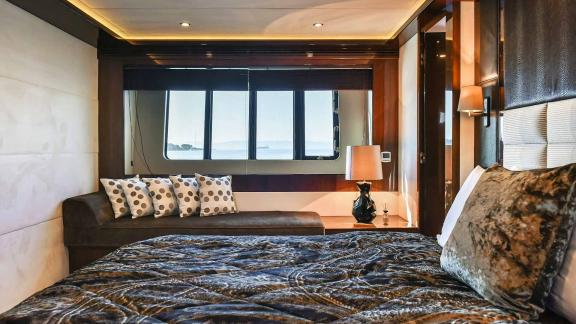 Stylishly furnished cabin with a large bed and panoramic windows aboard the Motoryacht Agave in Split.