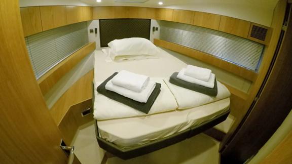 The comfortable bedroom of the Get Lucky motor yacht offers a cozy sleeping area.