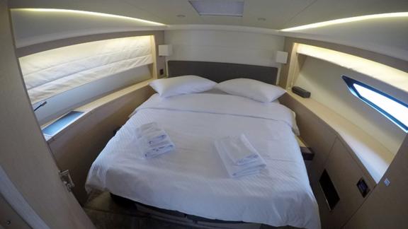 Spacious and comfortable cabin with a large bed on motor yacht Serendipity I.