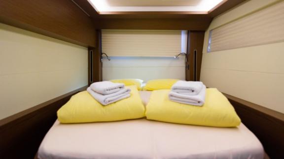 A spacious cabin on the Lagoon 50 with a double bed, soft lighting, and fresh linens for maximum comfort.