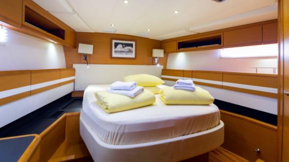 The spacious master cabin on Whyknot yacht features a comfortable bed and modern decor.