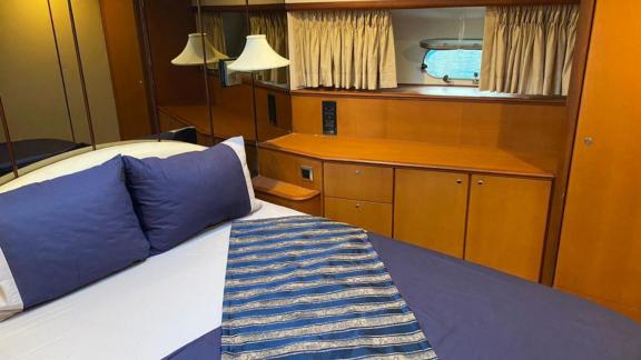 The master cabin of the motor yacht Ibiza features a comfortable bed and ample cabinet space.