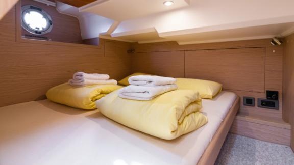 The double bedroom on the motor yacht Ocean Dreamer features a large bed and modern decor.