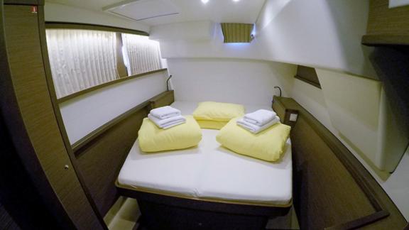 Comfortable double cabin with soft pillows and fresh towels for a restful sleep.