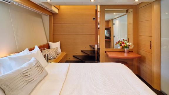 The bedroom on the Yacht For Ever includes a desk and stylish details.