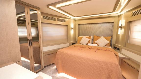 The guest cabin on yacht La Luna offers a cozy atmosphere with warm colors and modern design.