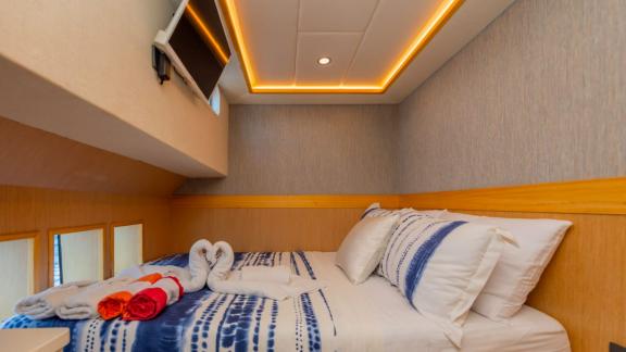 The cabin of trawler yacht Kaan Bey 2 features modern design and a comfortable bed.