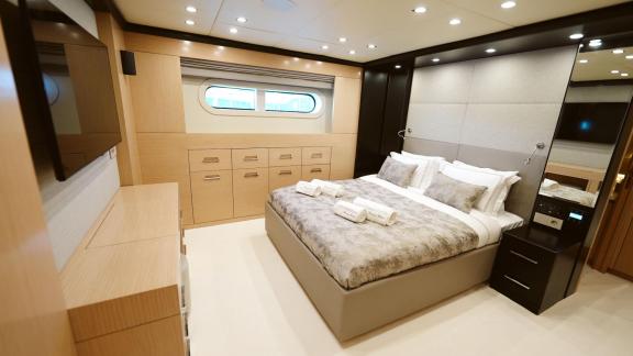 Comfortable bedroom on Princess Melda yacht with stylish design and large window view.