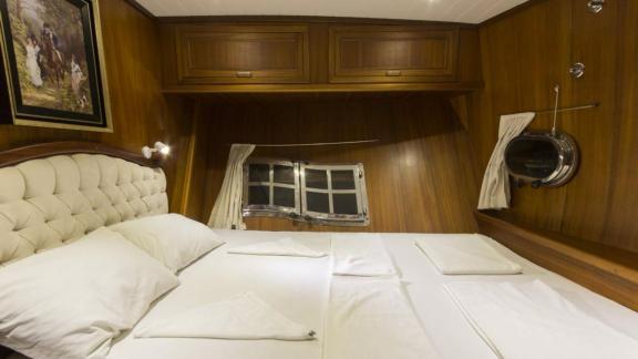 Double cabin with a bed on Gulet Cemre 4 featuring elegant design.