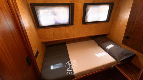 The cozy sleeping area in the cabin of Gulet Ayken offers a comfortable sleeping experience.