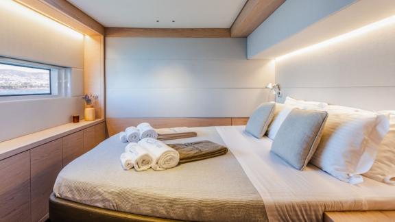 The spacious double cabin of White Caps catamaran features modern and comfortable decor.