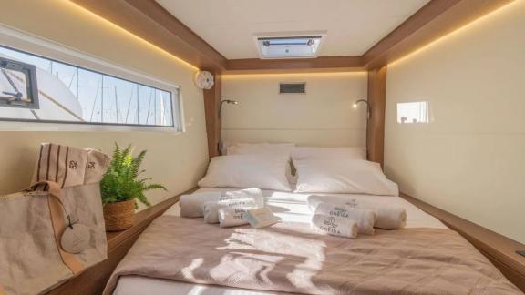 The double cabin on the Oneida 2 catamaran offers a comfortable sleep experience with a cozy bed and stylish details.