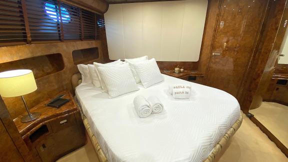 The guest cabin on Paula 3 yacht offers a luxurious bed and elegant design details.