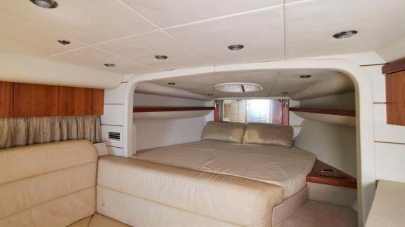 The main cabin of the Lady Boss motor yacht features a large, comfortable bed.