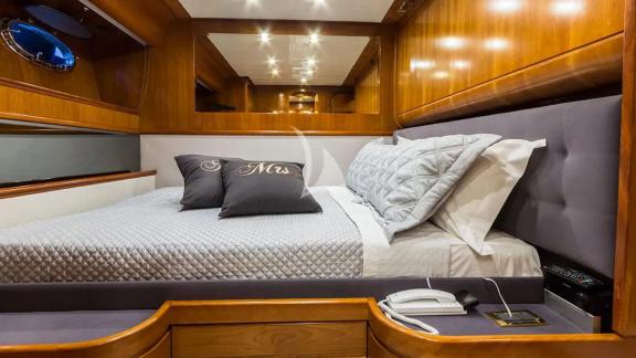 Comfortable double bed on yacht Amoraki with cozy pillows.