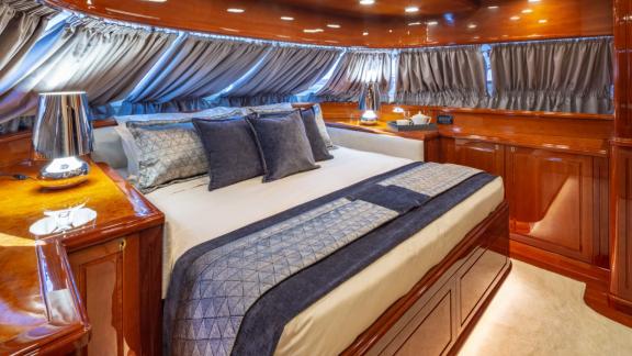 The master bedroom of Divine yacht features stylish curtains and luxurious decor.