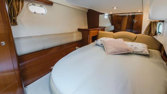 The bedroom of motor yacht Unplugged offers a simple and cozy sleeping area.