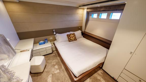 The spacious bedroom of the Tatii 2 luxury motor yacht offers an ideal experience for yacht rental in Dubai.