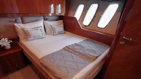 The comfortable double bedroom of the Notorious motor yacht completes your Dubai yacht rental experience with luxury and