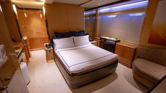 The cozy bedroom on Code 8 yacht completes your Dubai yacht rental experience.