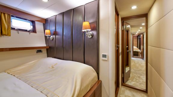 Comfortable guest cabin of the motor yacht Wide Liberty with stylish lighting features.