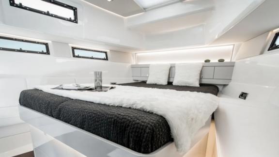 The master cabin of the Bombon motor yacht features a modern design with a spacious double bed and a bright atmosphere.