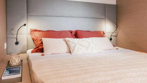The catamaran Kebisiks offers a cozy bed and soft lighting in a stylish cabin near Athens.