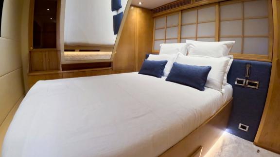 The VIP cabin of yacht Brooklyn offers a peaceful retreat with natural wood accents and warm lighting.