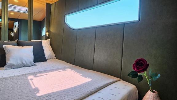 The Gold catamaran’s cabin offers peaceful rest with soft tones, large window and elegant simplicity.