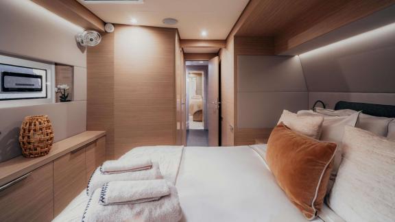 Inside Almosta Road is a cozy bed, window, towels and a door leading to the corridor.