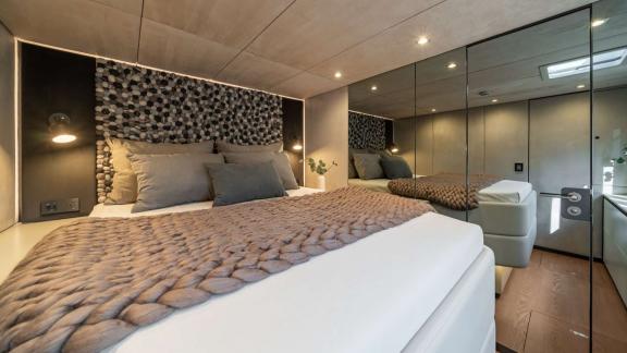 Spacious bed, textured headboard and modern style define the Sunreef 60 Ahalya.