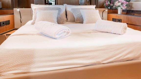 Motor yacht Kimani BG74 provides a refined master cabin featuring a spacious double bed and natural light.