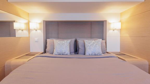 The Ariva features a cozy guest cabin with a large bed, soft lighting and elegant modern decor.